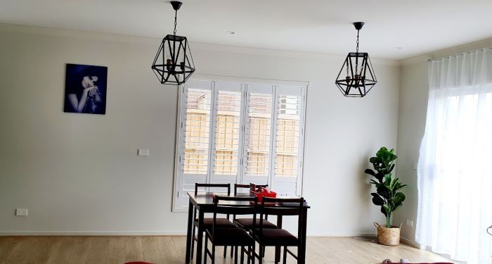 Bright Melbourne dining area with plantation shutters optimizing natural light.