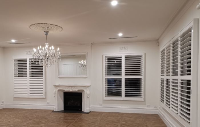 White plantation shutters in a minimalist home.