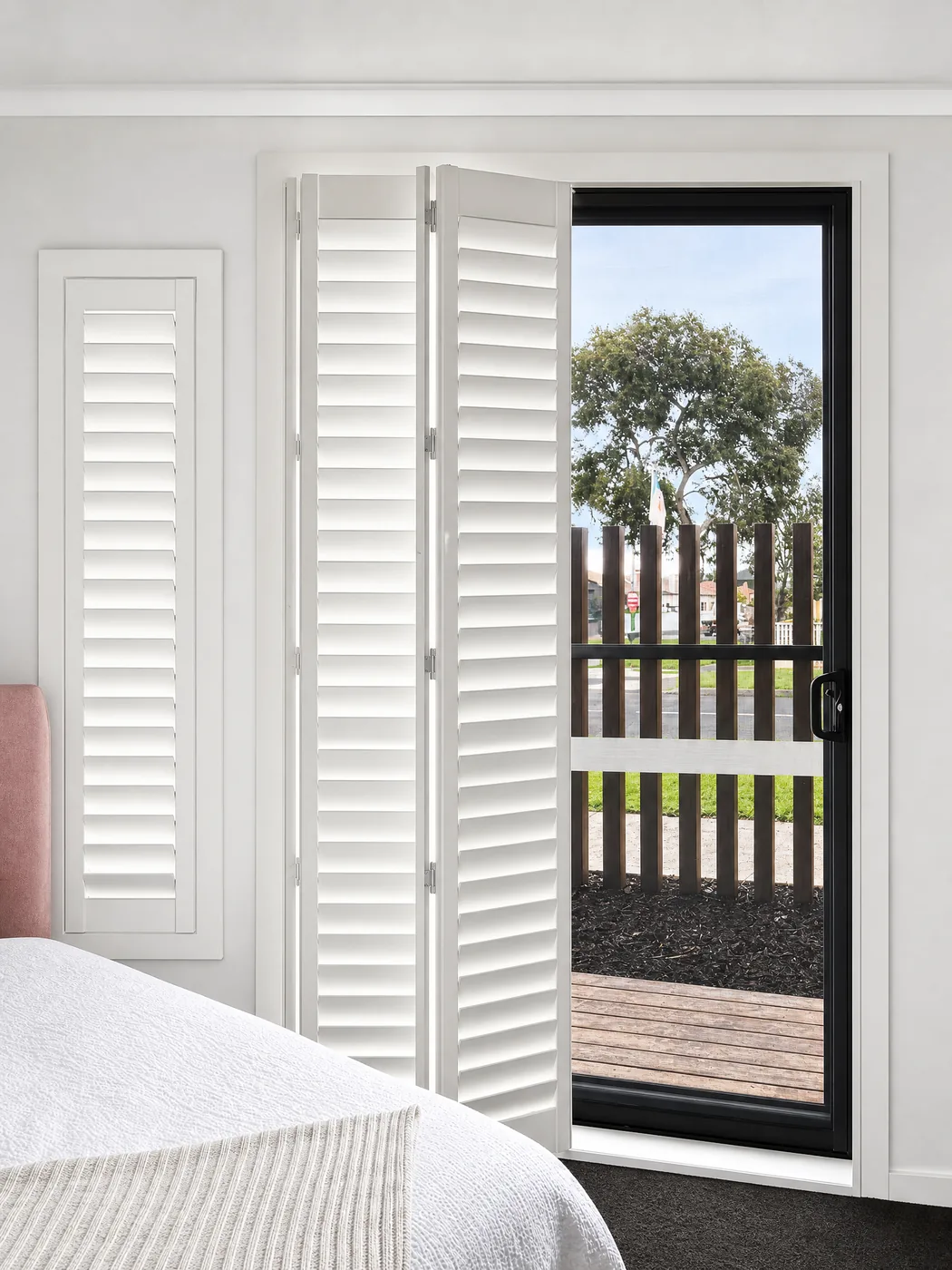 Bi-fold plantation shutters Melbourne bedroom — adjustable louvre blades for light and privacy control