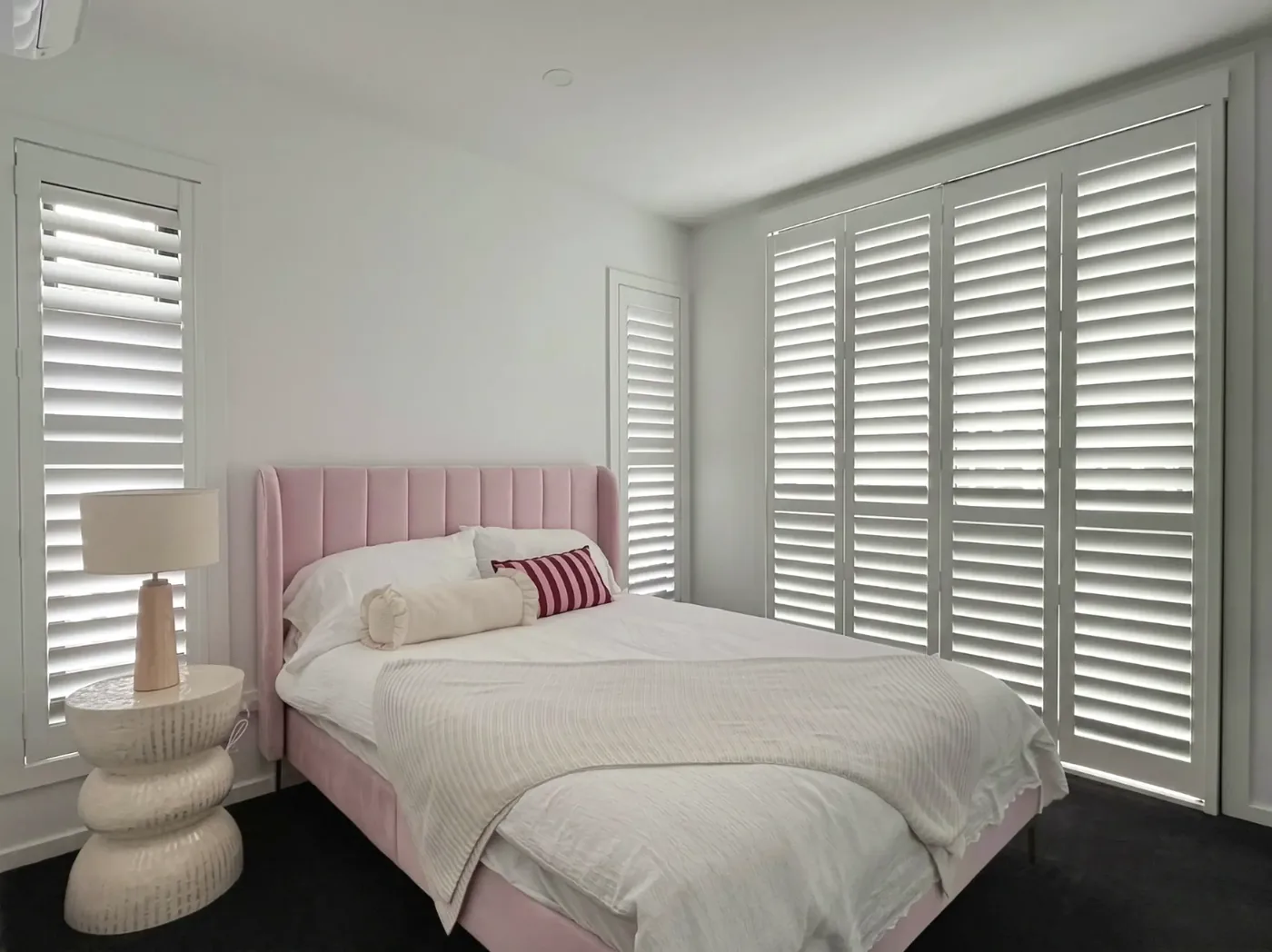 Window shutters Melbourne bedroom — custom plantation shutters installed on full-height windows