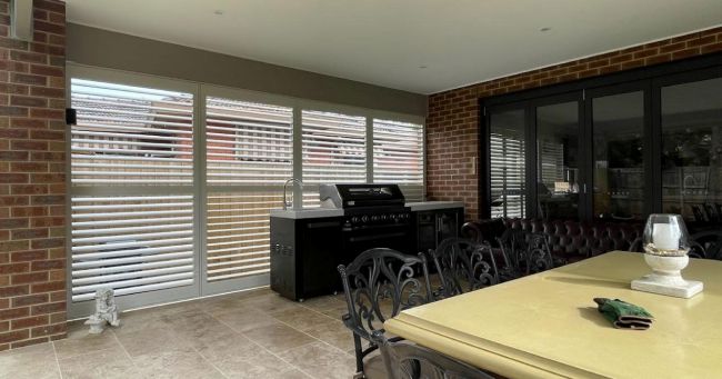 Custom outdoor plantation shutters for a covered deck