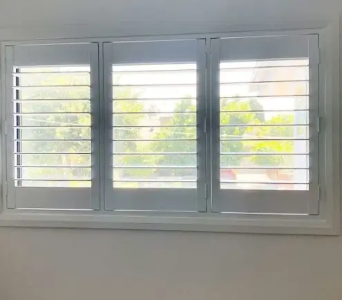 PVC hinged shutter panels opened on a lounge window