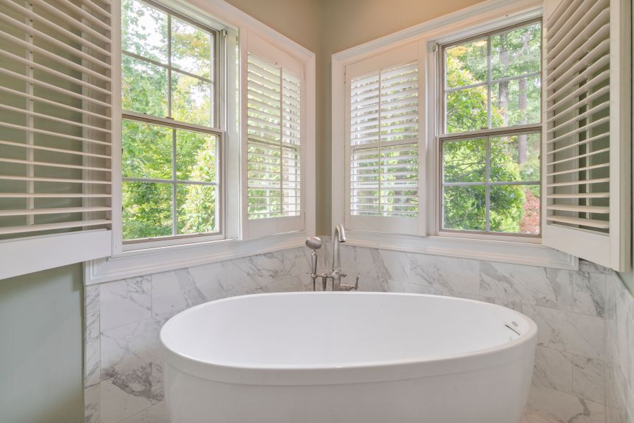 Bathroom window with white PVC shutters