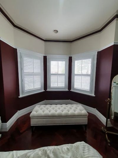 Custom plantation shutters fitted to a bay window